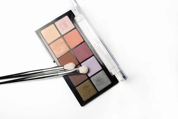 Paleta de sombra de ojos colorida con pinceles de maquillaje en un bac blanco — Foto de Stock