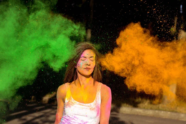 Beautiful young woman with short hair posing with exploding gree — Stock Photo, Image
