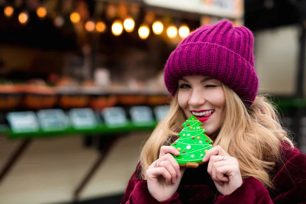 Emotional young woman holding sweet christmas gingerbread, posin — Stock Photo, Image