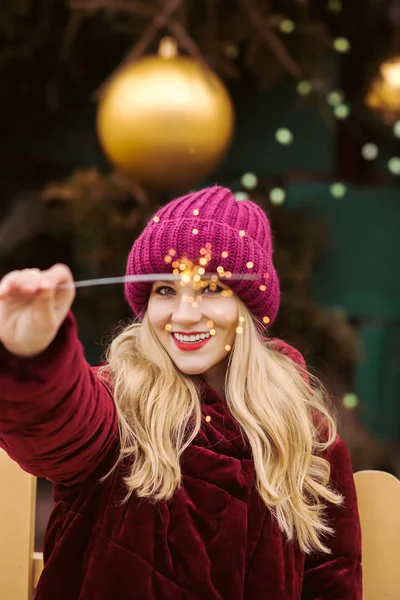 Closeup portrait of cheerful woman dressed in warm clothes, hold — Stock Photo, Image