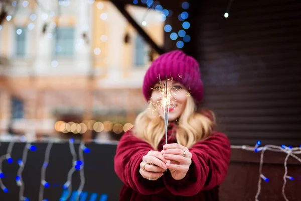 Funny blonde girl holding glowing Bengal lights at the Christmas — Stock Photo, Image