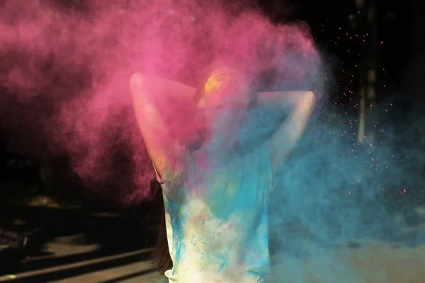 Young brunette model posing with Holi powder exploding around he — Stock Photo, Image