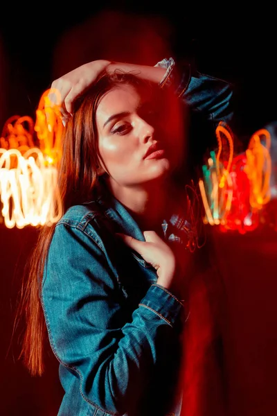 Sensual brunette woman posing in mixed light technique at the ni — Stock Photo, Image