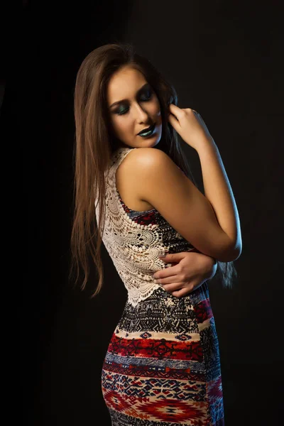 Adorable young woman with long hair and creative metallic makeup