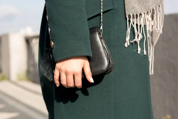 Closeup shot of fashionable dressed woman in green coat wearing — Stock Photo, Image