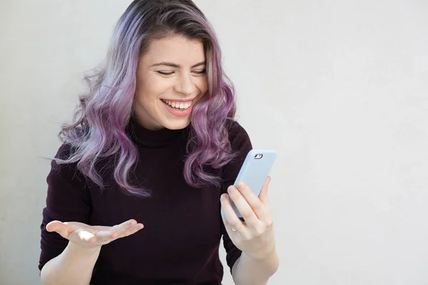 Cheerful woman looking on her mobile phone — Stock Photo, Image
