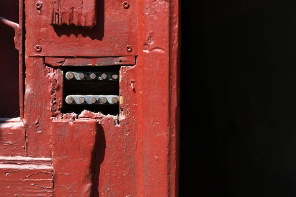 Old painted wooden door with a code lock on a street of Lviv, Ukraine. Closeup shot