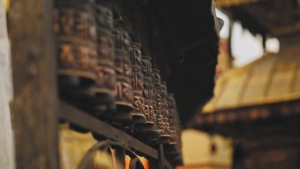 Buddhist polished carved rithual wheels spin at Swayambhunath temple, hand touch — Stock Video