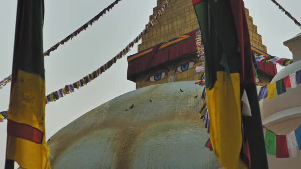Insightful Buddhas eyes look from golden pinnacle of Boudhanath stupa, Kathmandu — Stock Video