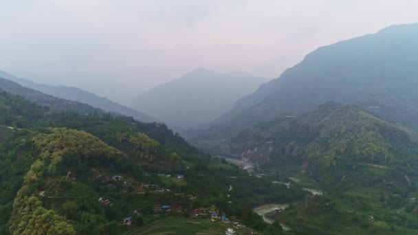 Panorama above misty rural forest slopes over river valley — Stock Video