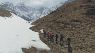 Turistler yürüyüş yapıyor, Annapurna II, Nepal 'deki karlı dağ eteklerine yolculuk yapıyor.
