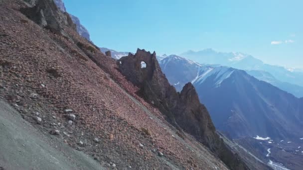 Highland scree slope, incredible crest cliff with round hole, tourists trekking — Stock Video