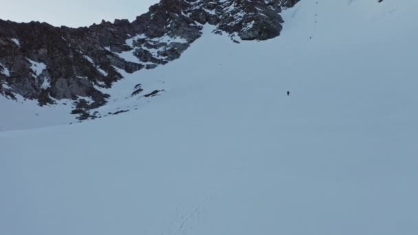 Сліди альпіністів на гірському схилі, альпіністи рухаються через снігові перешкоди — стокове відео