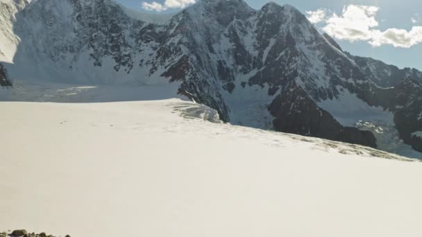 Scenic alpine panorama, rocky mountain, blue sky, snowy glaciers shining bright — Stock Video