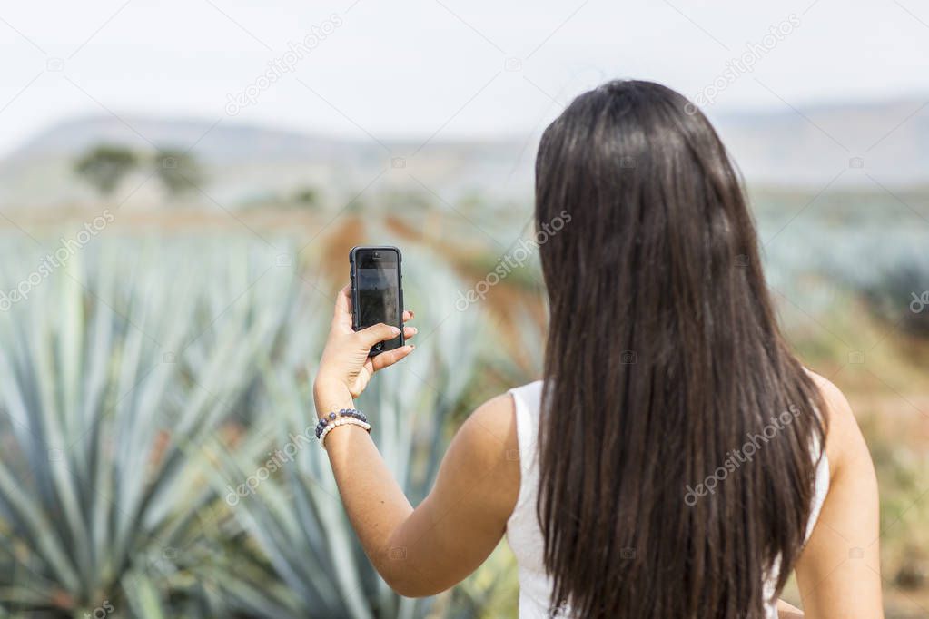 Mexican woman in a landscape of Tequila.