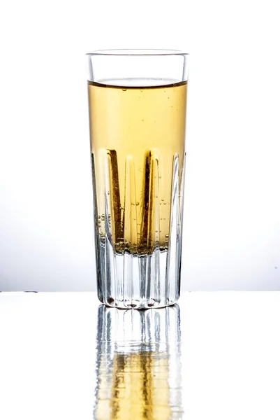 Tequila shot in een spiegel geïsoleerd op witte achtergrond — Stockfoto