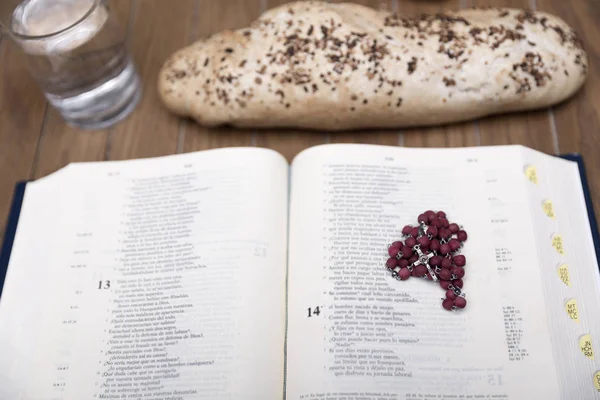 Bible, bread and water on wooden table — Stock Photo, Image