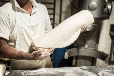 öğretmen baker masada ekmek üretiminde elinde