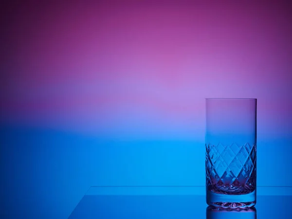 Glass close-up neon colored light gradient background
