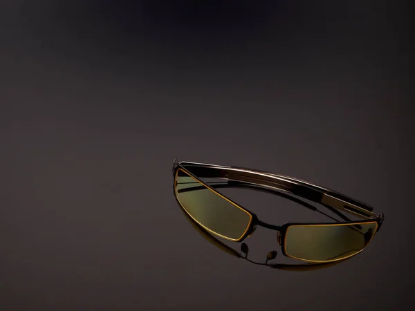 Computer game protective UV glasses on a gray gradient background