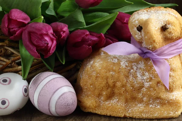Easter decoration  / easter lamb cake with purple ribbon, eggs and tulips