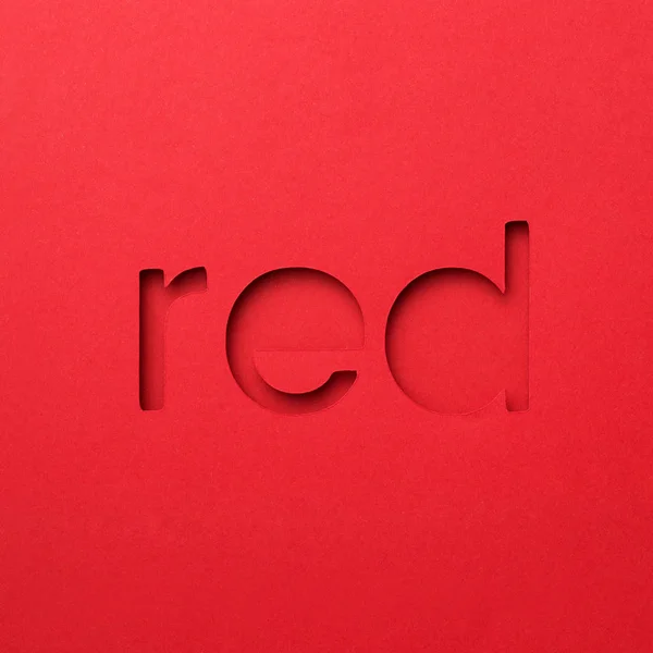 Czerwony słowo wykonane z papieru na czerwonym tle — Zdjęcie stockowe