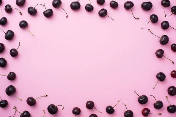 Cherries over pink background — Stock Photo, Image