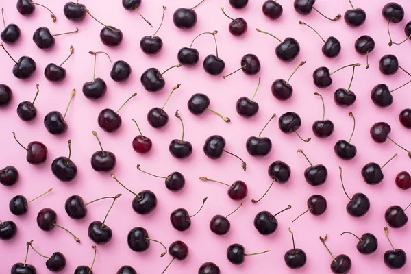 Cherries over pink background — Stock Photo, Image