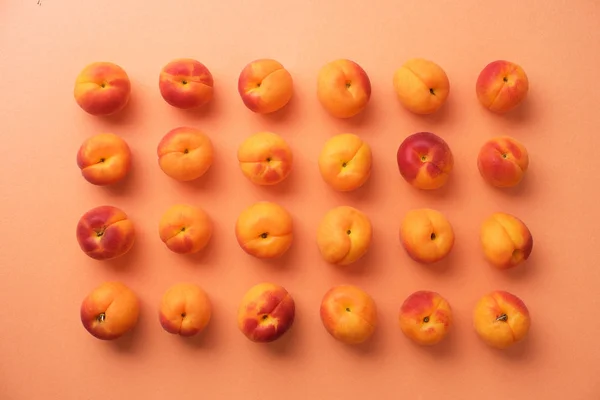 Apricots over orange background — Stock Photo, Image