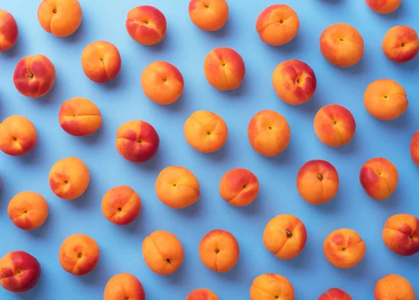 Apricots over blue background — Stock Photo, Image