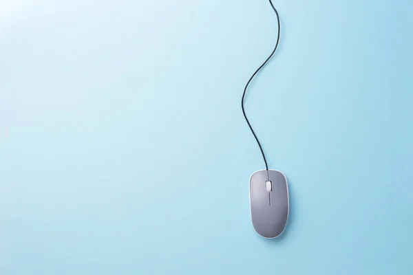 Gray computer mouse over blue background — Stock Photo, Image