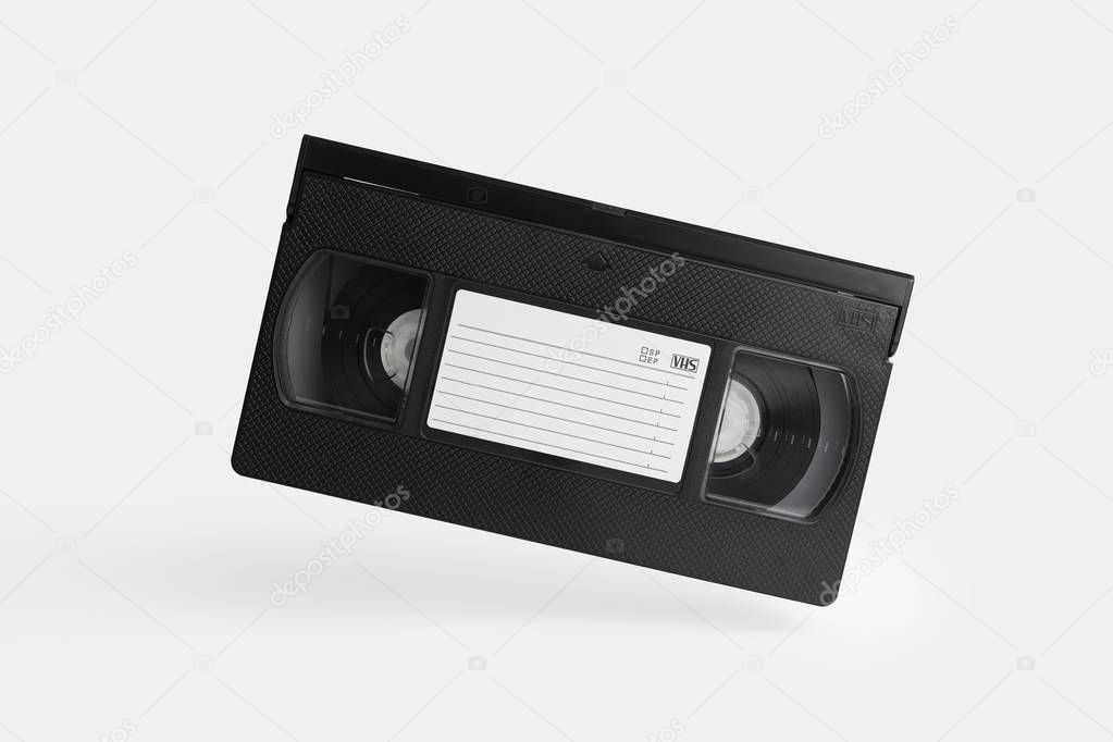 VHS Cassette in the air over white background