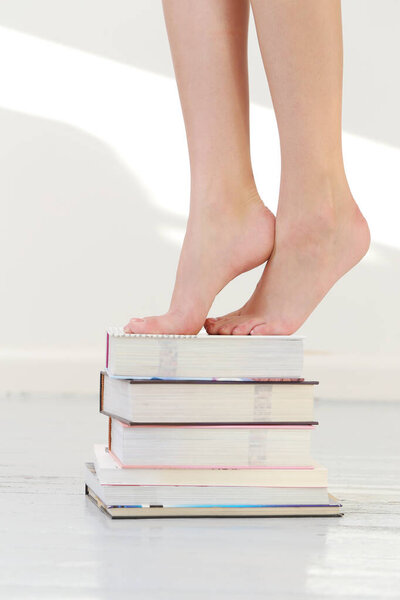 Woman standing at the book pile