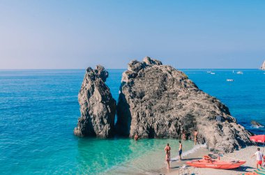 Giant rock in the middle of sea near beach in Five Earths, Italy