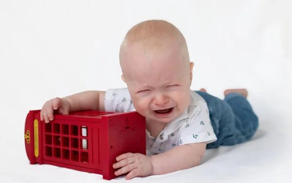 ロンドンの電話ブースモデルと泣いてジーンズを身に着けている赤ちゃん — ストック写真