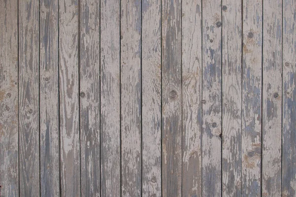 Kırsal bir ülkede eski ahşap panellerden yapılmış arka planda çiviler ve eski boyalar.