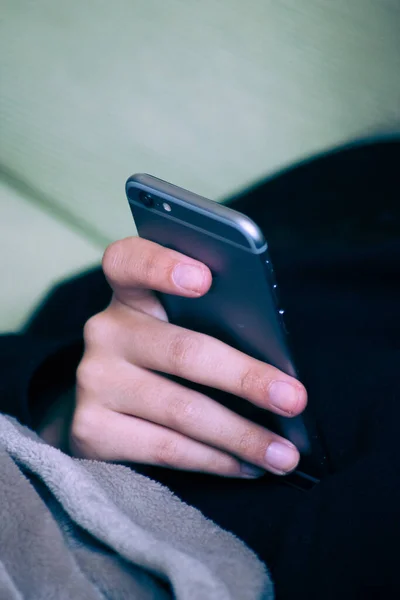 close-up of a woman\'s hand with a smartphone in a cold environment