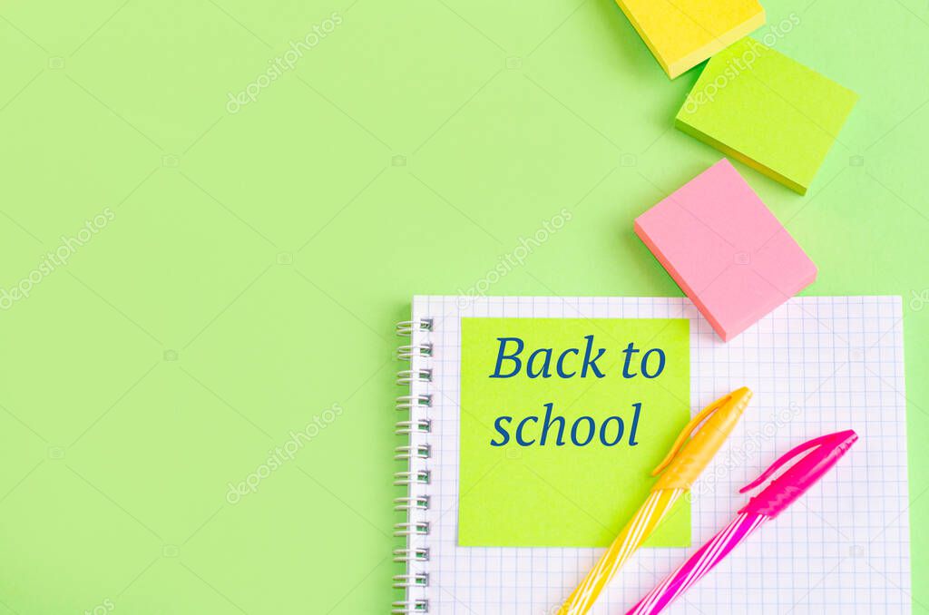 Back to school concept. School and office supplies on office table, green background. Flat lay with copy space.