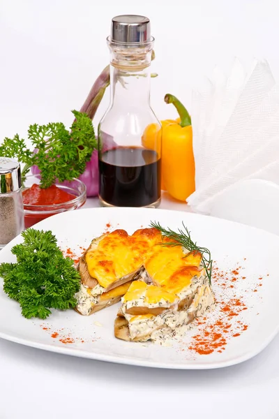 Eggplant baked with cheese and garlic with parsley and dill on a — Stock Photo, Image