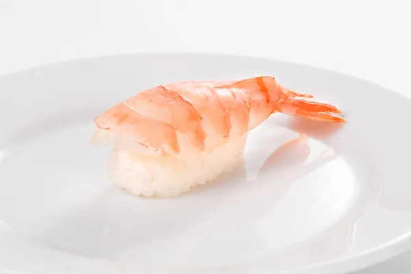 Sushi with tiger shrimp on a white plate on a white background. — Stock Photo, Image