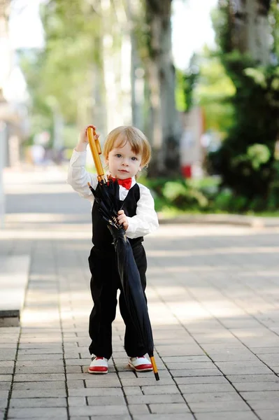 Child with umbrella in hands — Stock Photo, Image