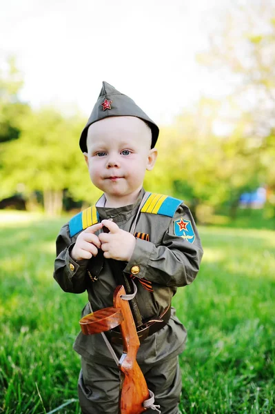 Child in military uniform against nature background — Stock Photo, Image