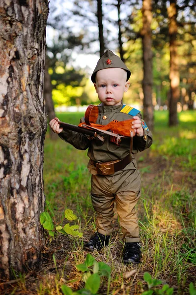 Child in military uniform against nature background — Stock Photo, Image