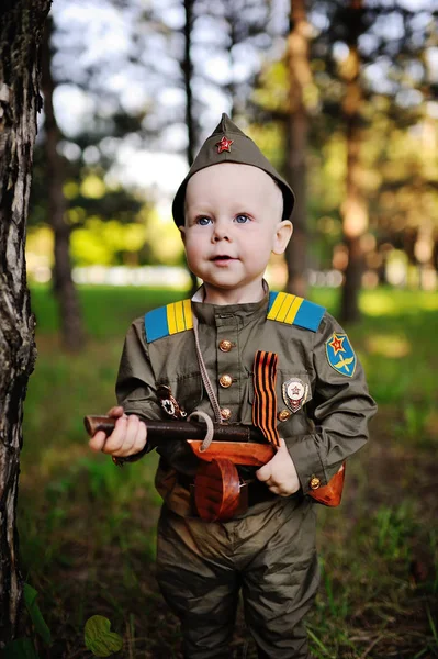 Child in military uniform against nature background — Stock Photo, Image