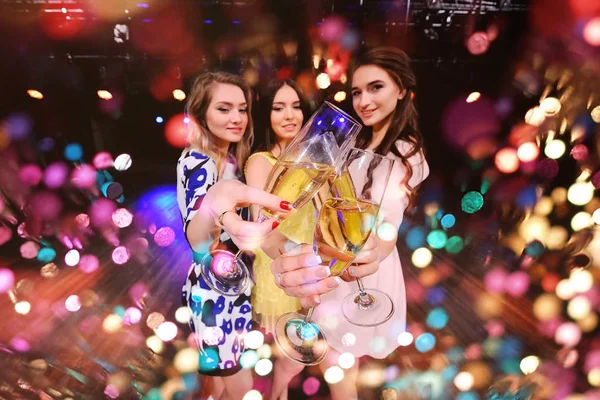 Three pretty young girls with glasses of champagne — Stock Photo, Image