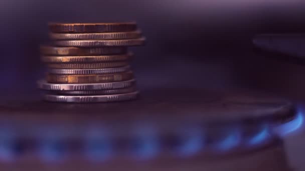 A stack of iron coins on a gas burner close-up. — Stock Video