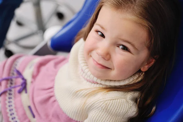 Little girl in a blue dental chair — Stock Photo, Image