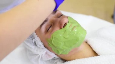 woman in a beauty clinic makes the procedure Alginate mask