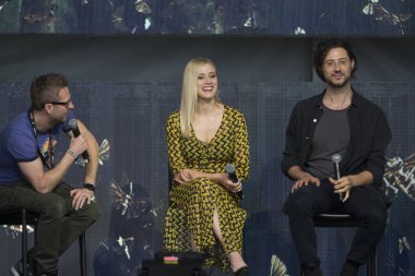 Mountain View, CA/USA: 6/24/17: Chris Hardwick (left) asks cast of The Magicians Olivia Taylor Dudley and Hale Appleman questions at ID10T Festival. 