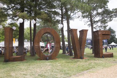 Napa, CA/USA: 5/28/17:  Festival patrons take photos and relax at the LOVE art feature at BottleRock 2016 in Napa, CA.  